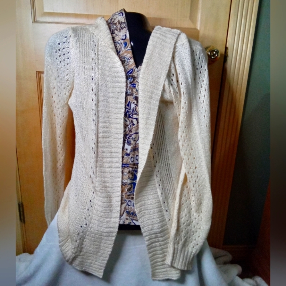 Women's cream colored hooded open front cardigan.